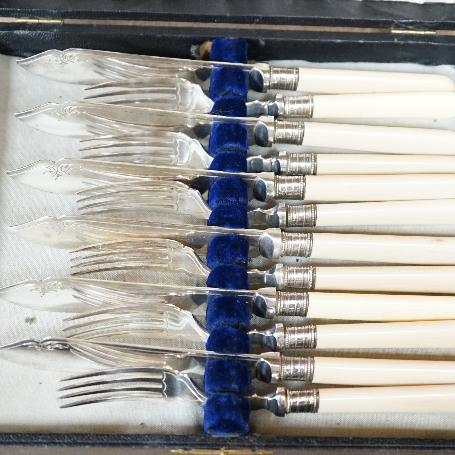 A group of assorted cased flatware comprising a set of six silver coffee spoons, Birmingham 1949, 100 grams, a silver fork and plated spoon christening set, fork 49 grams, a set of five Edwardian silver teaspoons and ton